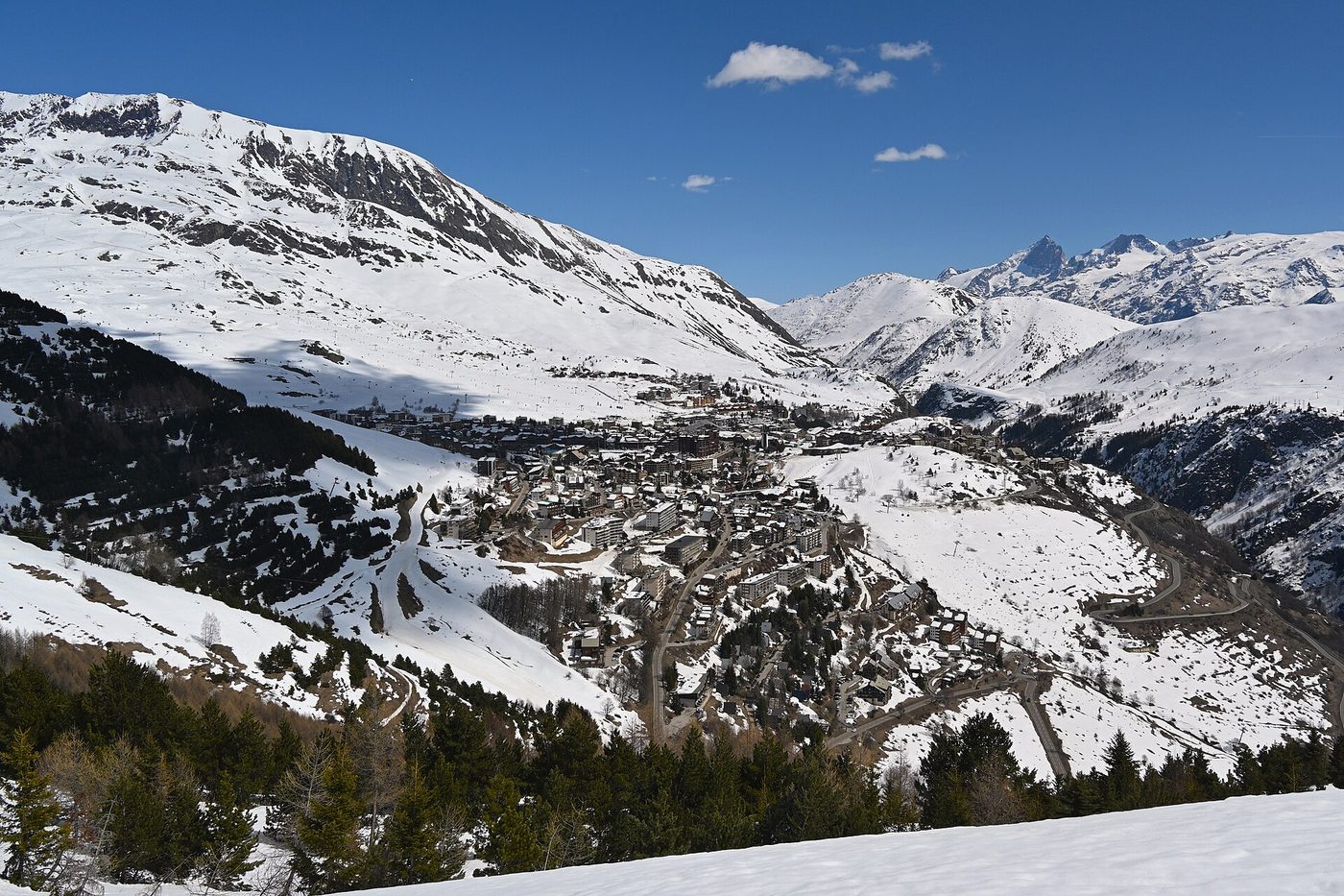 Aerial wide view of the resort town of Alpe d’Huez in its snow-covered mountain setting