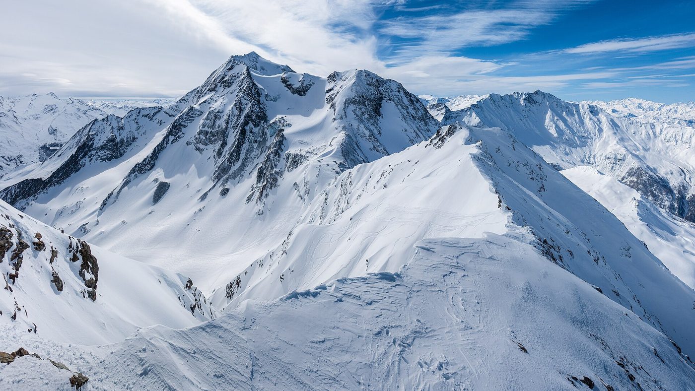 Sweeping winter panorama of Mont Pourri and the snow-covered Paradiski mountains seen from the Aiguille Rouge summit above Les Arcs